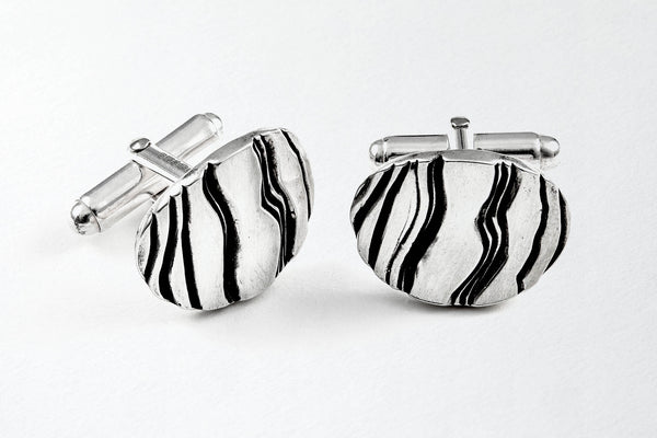 Silver oval striped, oxidised cufflinks, which have been Hallmarked in Sheffield.