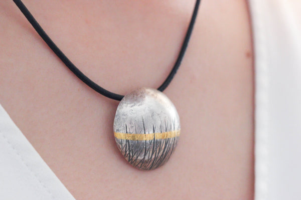 Textured oxidised silver, with a 24 carat gold stripe, choker. A wearable statement piece of jewellery